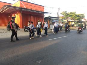 Pastikan Arulin Lancar, Bhabinkamtibmas Polsek Telagasari Lakukan Gatur dan Bantu Sebrangkan Siswa